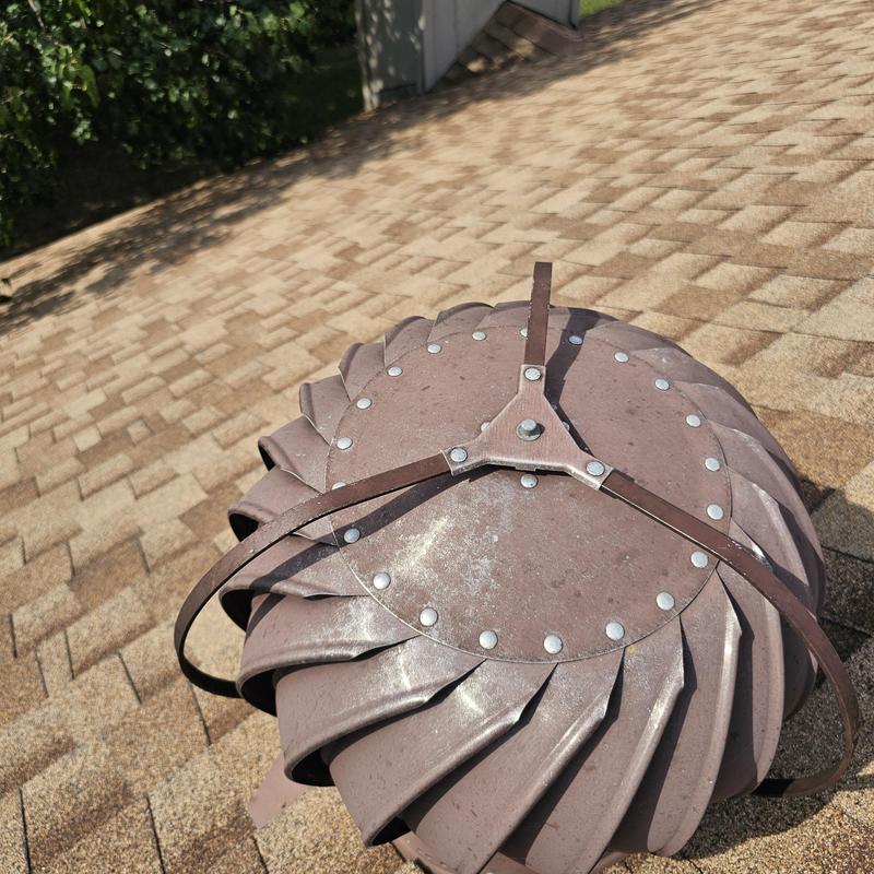 Turbine vent on shingle roof with hail damage