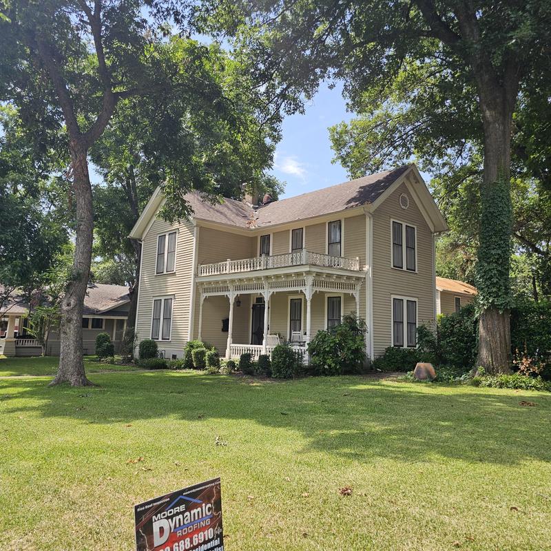 Asphalt shingle roof with hail damage on historic home