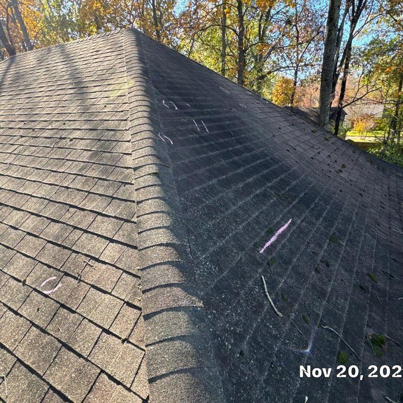 Asphalt shingle roof with storm damage inspection marks
