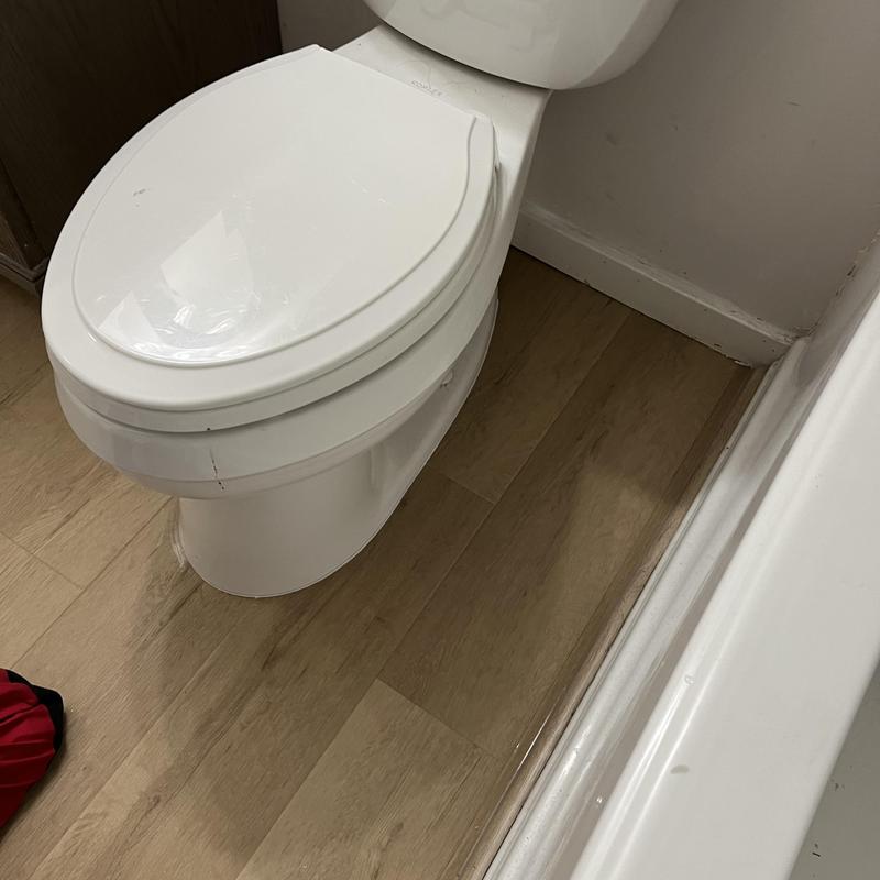 Toilet installation with new wax seal and flooring