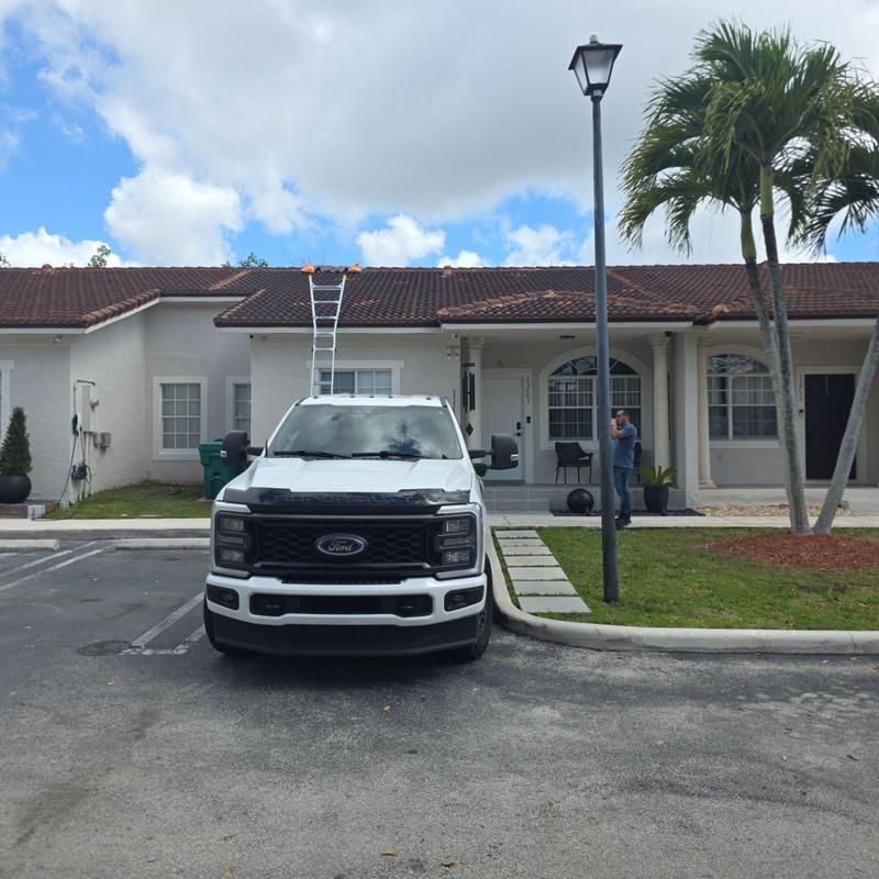Tile roof with ladder and truck at townhouse Tile roof with ladder and truck at townhouse