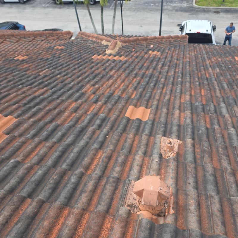 Tile roof with damaged and replaced tiles on townhouse Tile roof with damaged and replaced tiles on townhouse
