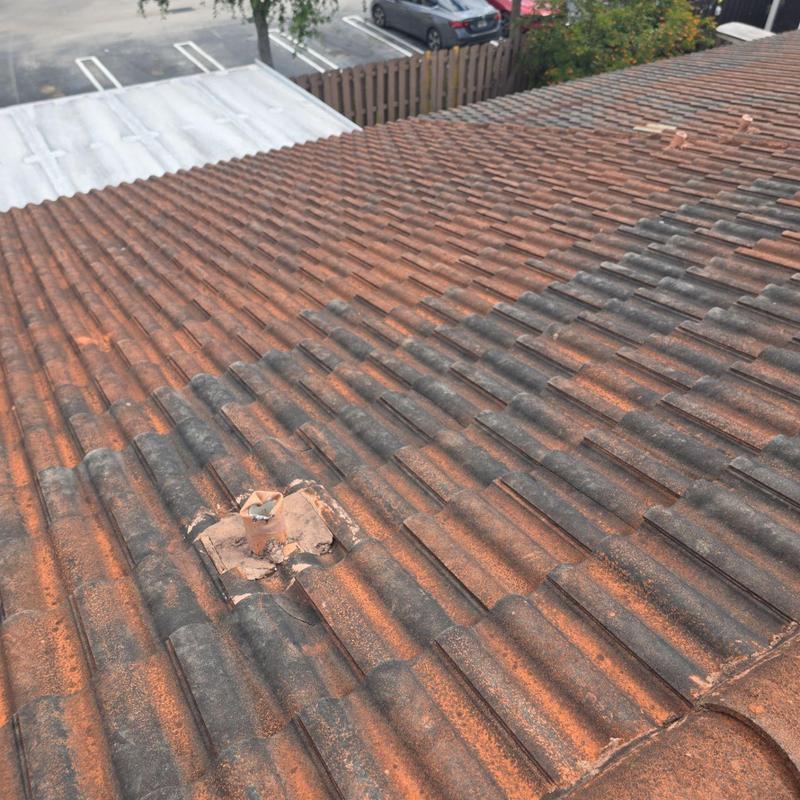 Tile roof with damaged tile and mounting bracket Tile roof with damaged tile and mounting bracket