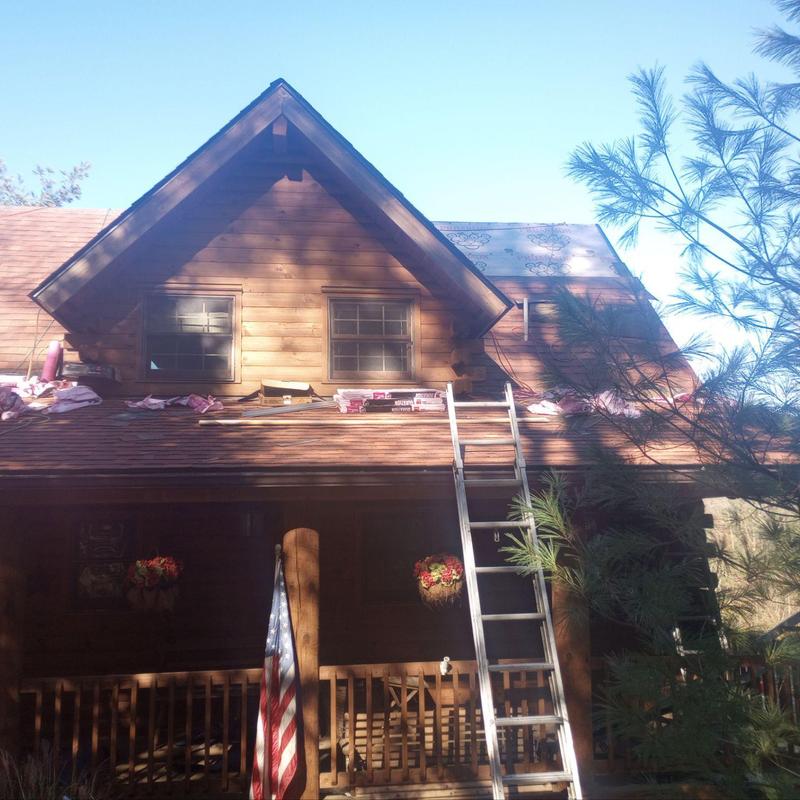 Log cabin roof with ladder and roofing materials Log cabin roof with ladder and roofing materials