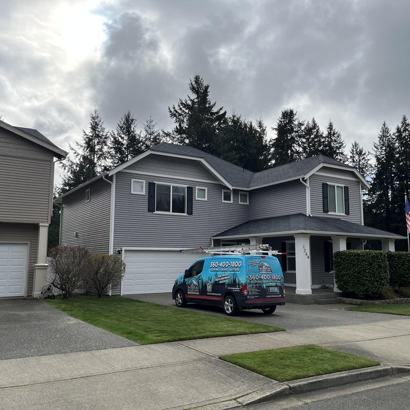 Asphalt shingle roof on residential house with service van