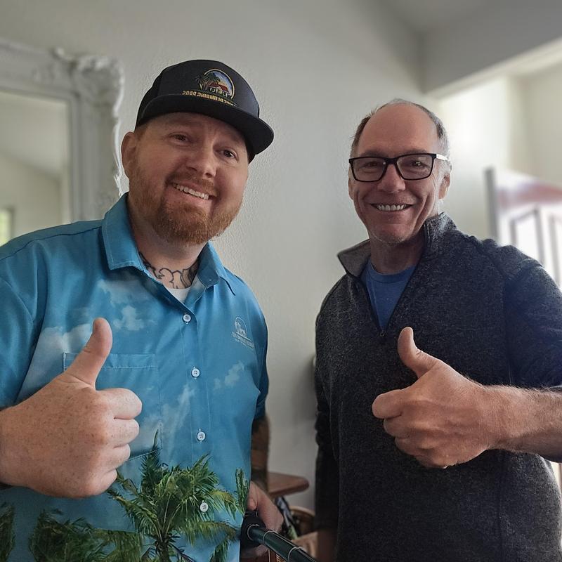 Kitchen sink drainage with two men giving thumbs up