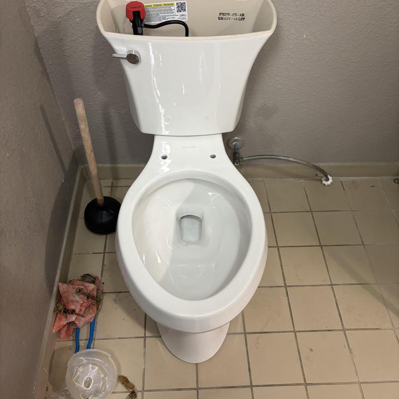 Toilet with open tank and disconnected water supply line