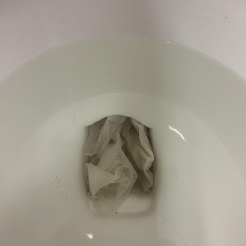 Toilet bowl with clogged paper obstruction Toilet bowl with clogged paper obstruction