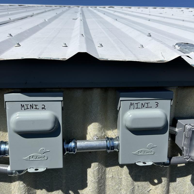 Mini split disconnect boxes mounted on exterior wall