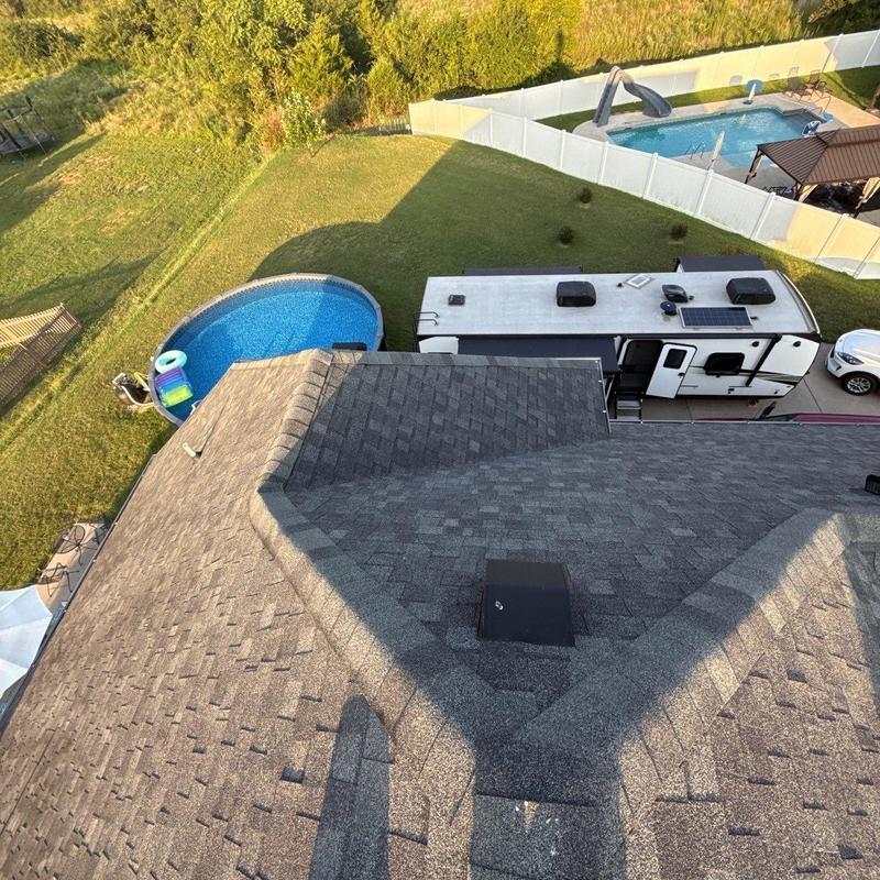 Asphalt shingle roof inspection with RV in driveway