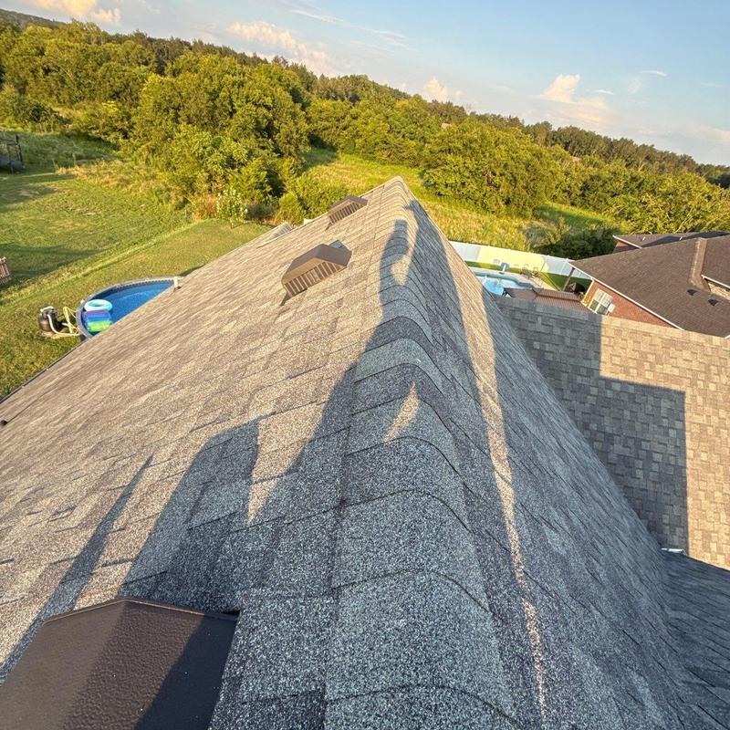 Roof shingles with hail damage and impact marks