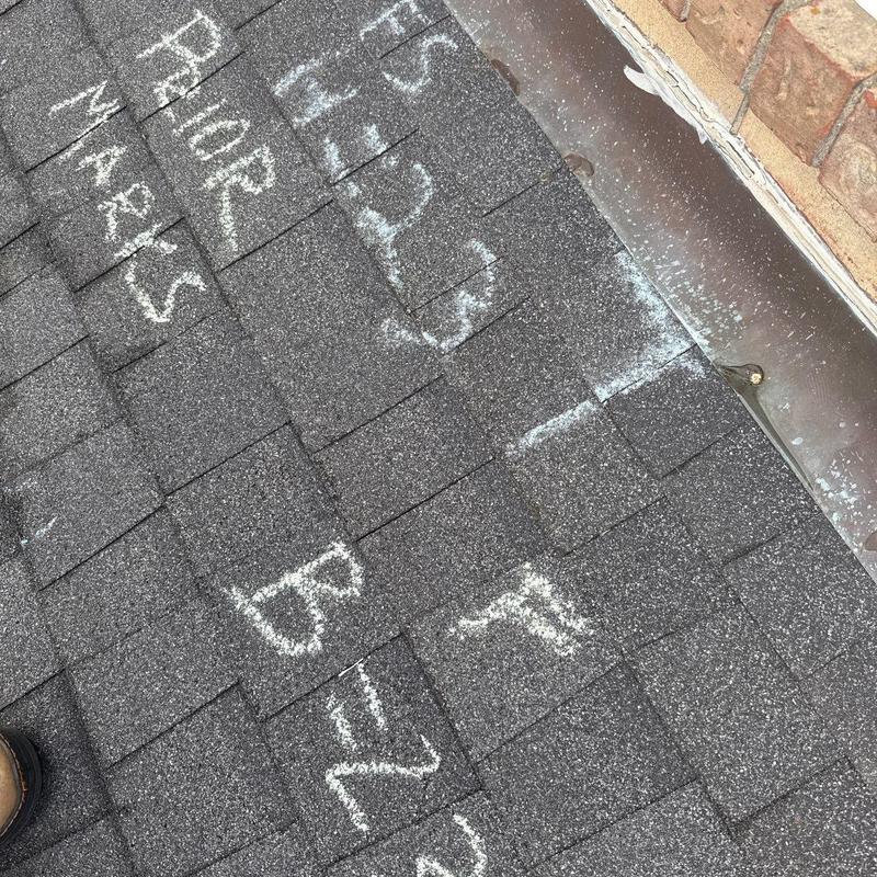 Asphalt shingle roof with hail damage markings