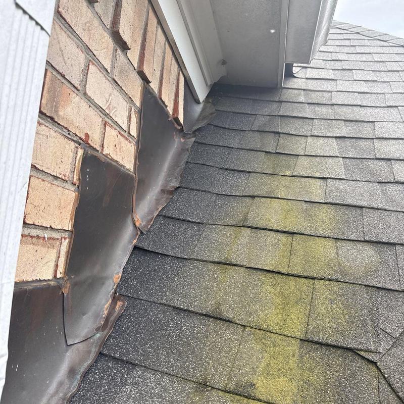 Roof shingles and flashing with hail damage and granule loss