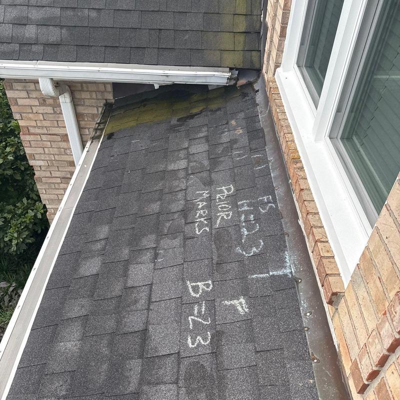 Roof shingles with hail damage and chalk markings