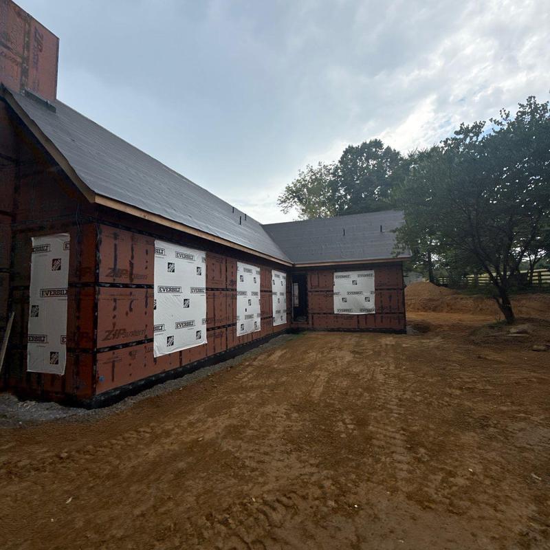Roof sheathing and weather barrier installation on new house
