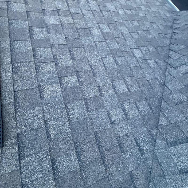 Asphalt roof shingles with hail damage on residential roof