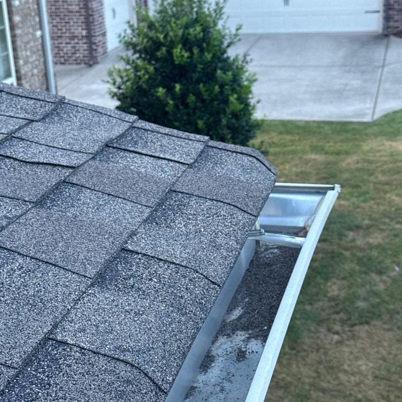 Asphalt shingles and gutter inspection with debris present