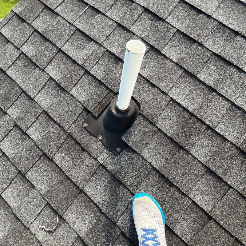 Roof flashing and vent pipe on shingled roof