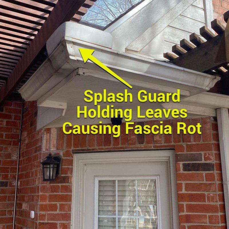 Splash guard with debris causing fascia rot
