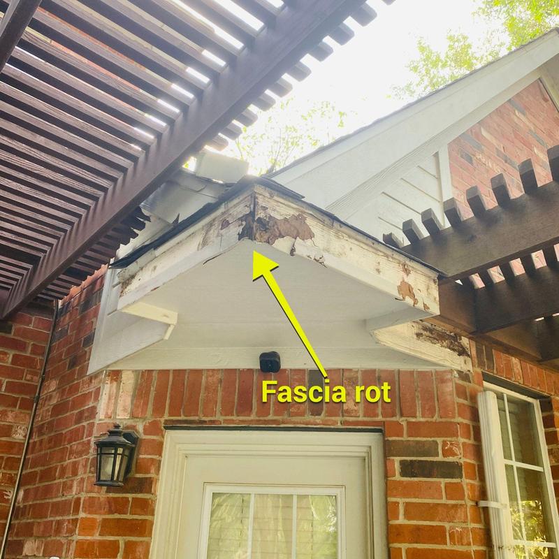 Fascia board with rot and water damage above door
