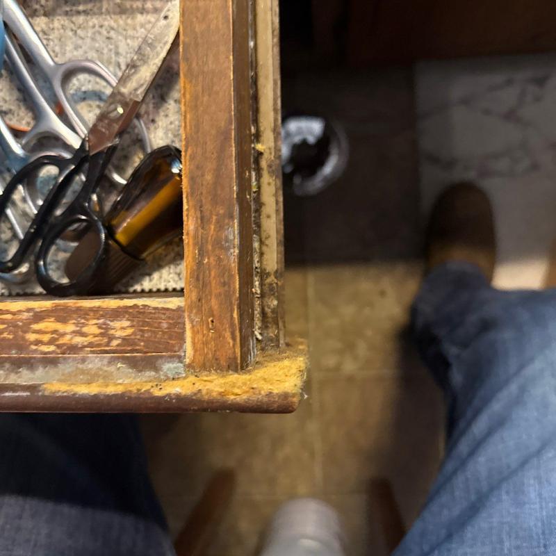 Wooden drawer with worn edges and tools inside