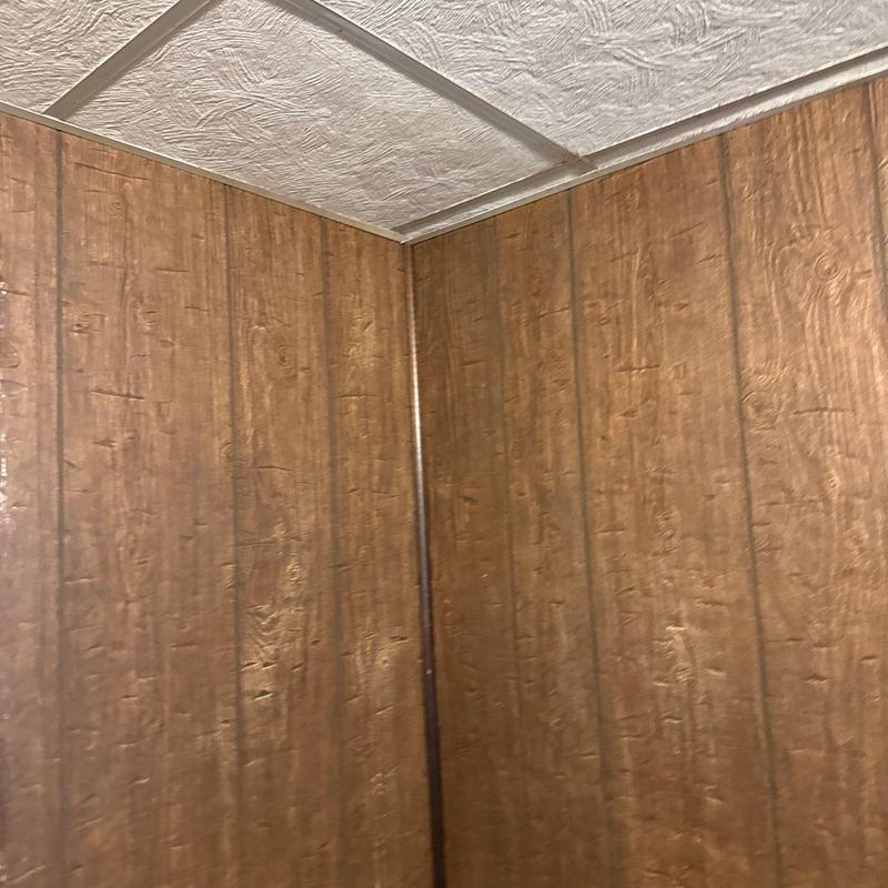 Wood panel wall with textured ceiling corner