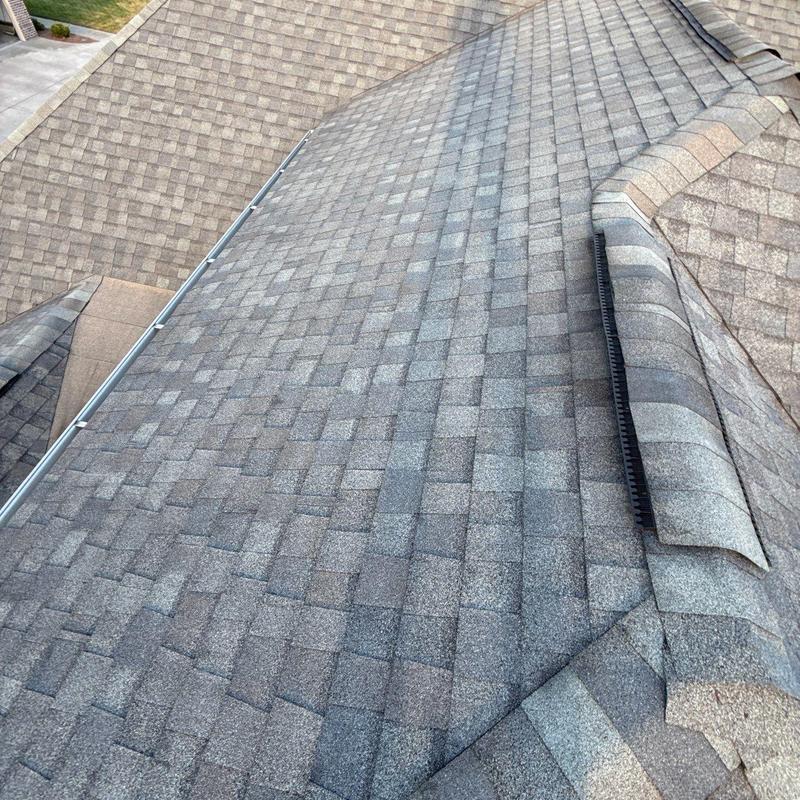 Asphalt shingle roof with hail damage and flashing issues