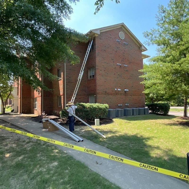Roof gutter replacement with caution tape barrier
