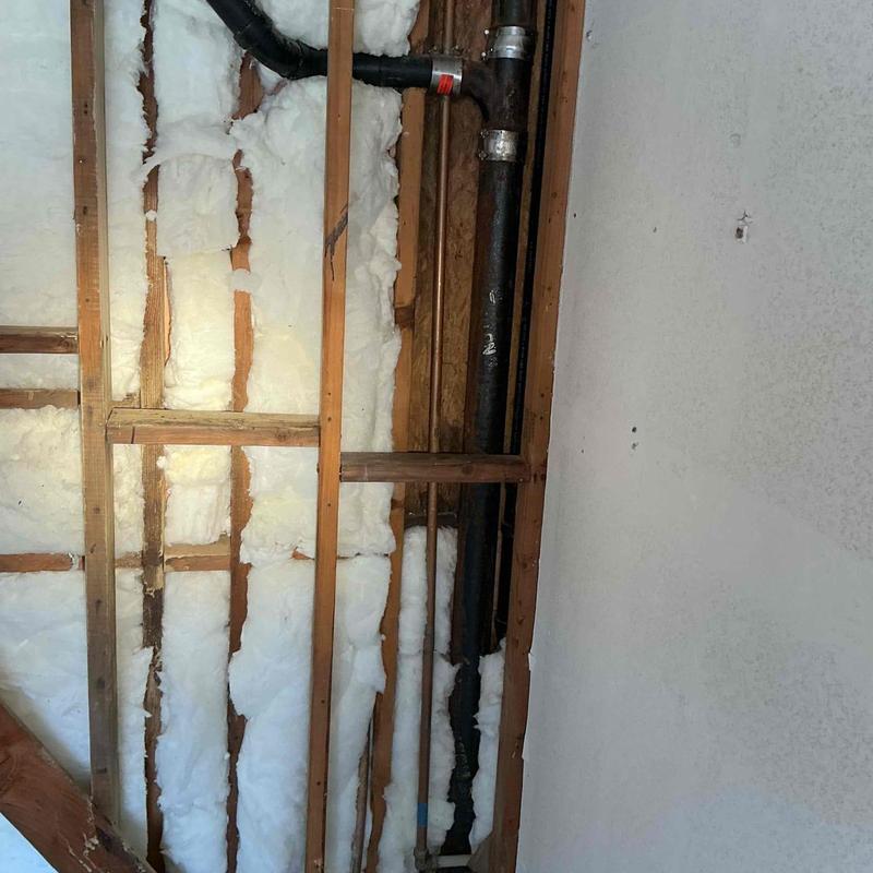 ABS drain piping installation with wood framing and insulation
