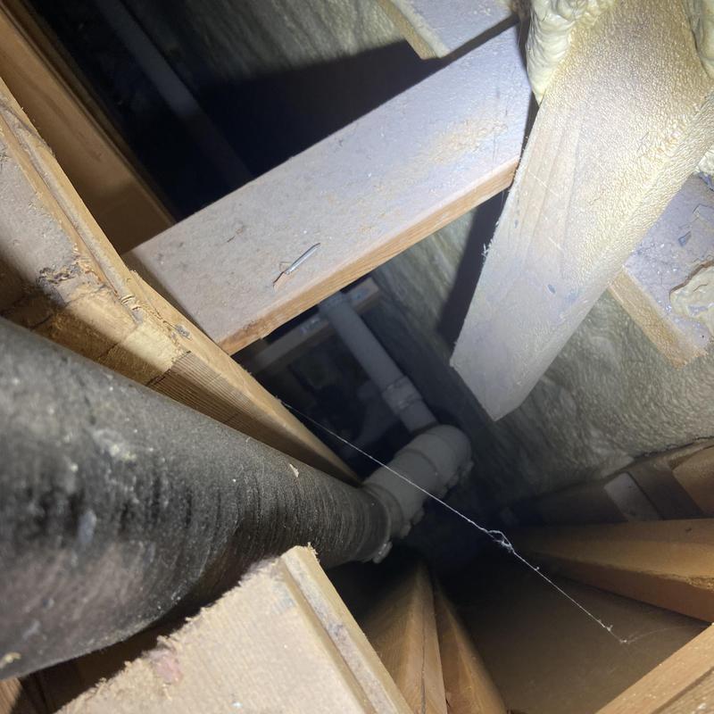 Cast-iron vent pipe with improper bracing in ceiling space