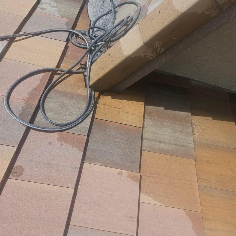 Concrete tile roof with water test and repair in progress