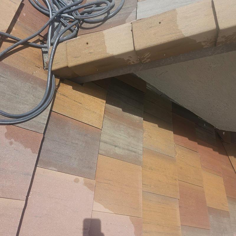 Concrete tile roof with water stains near flashing and wiring
