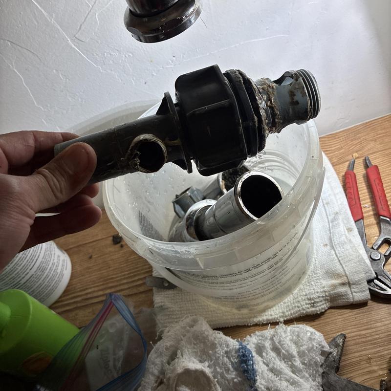 Bathroom sink pop-up assembly with leak damage