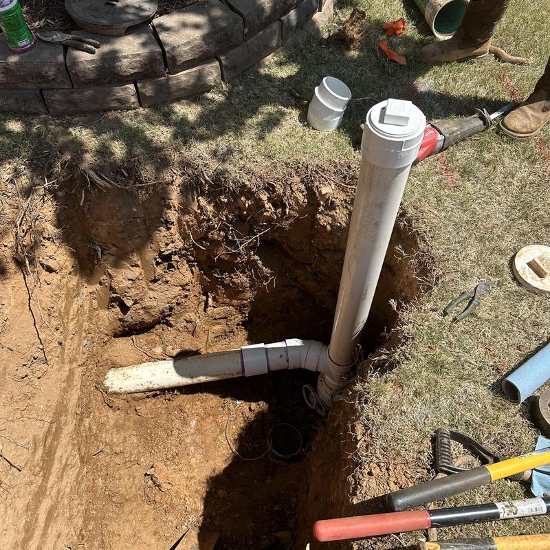 Sewer main cleanout pipe installation in yard