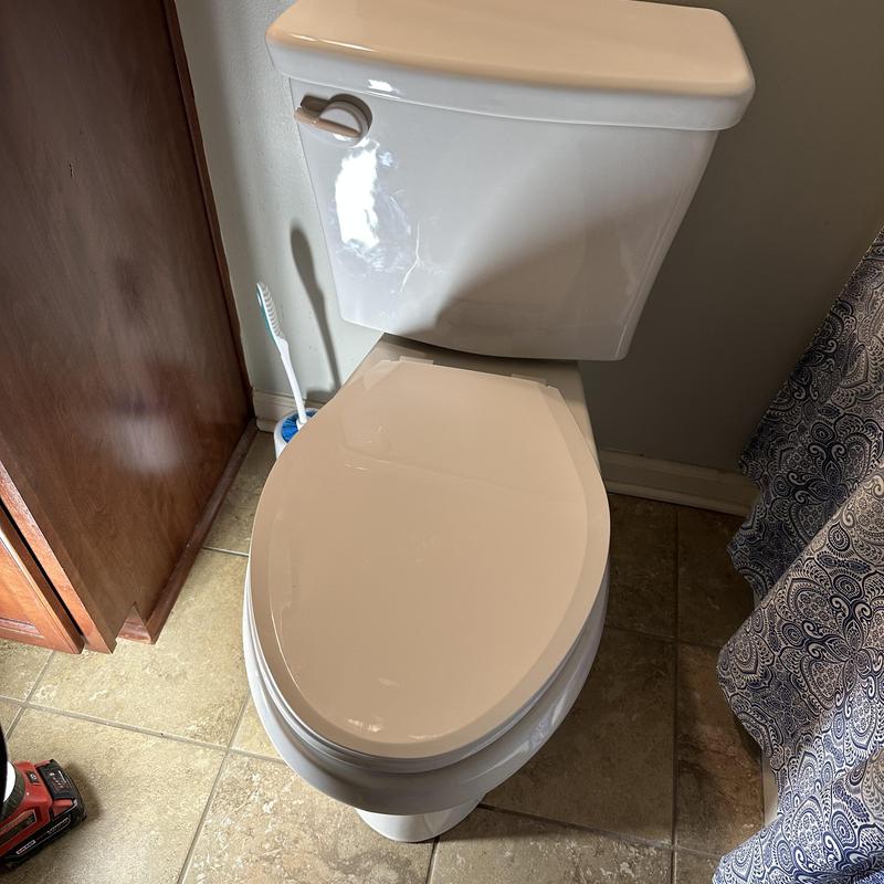 Toilet installation in bathroom with tiled floor