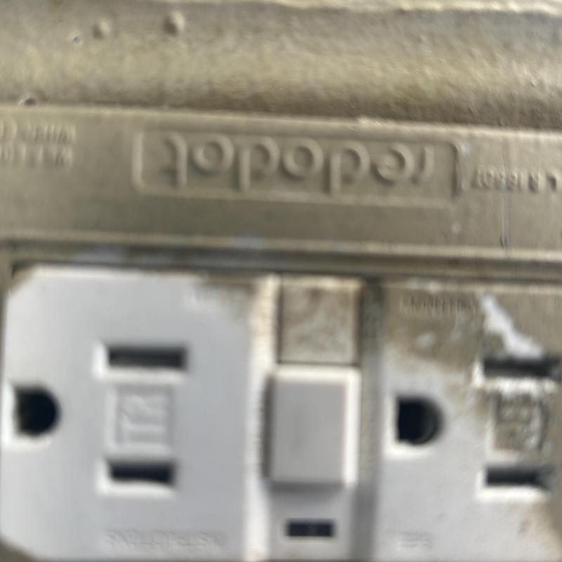 GFCI electrical outlet with reset button and dirt marks