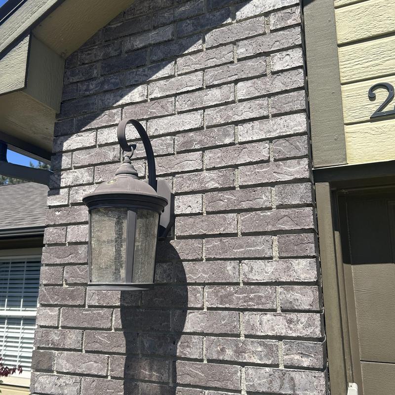 Outdoor wall light fixture on brick exterior