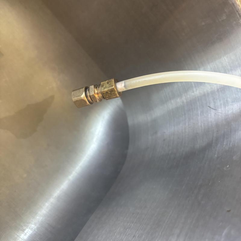 Refrigerator water line connection and tubing close-up