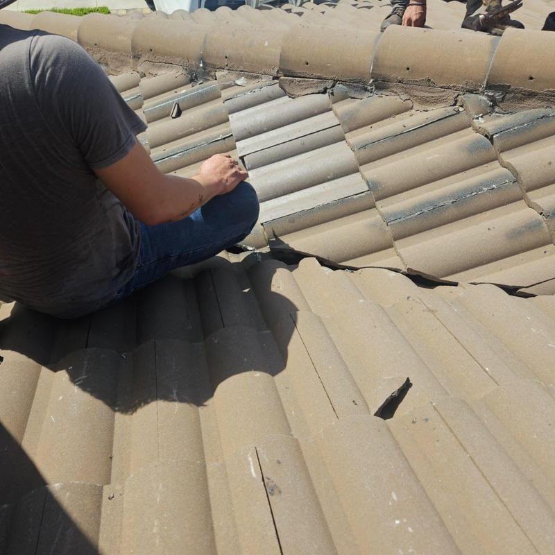 Concrete tile roof with damaged and displaced tiles