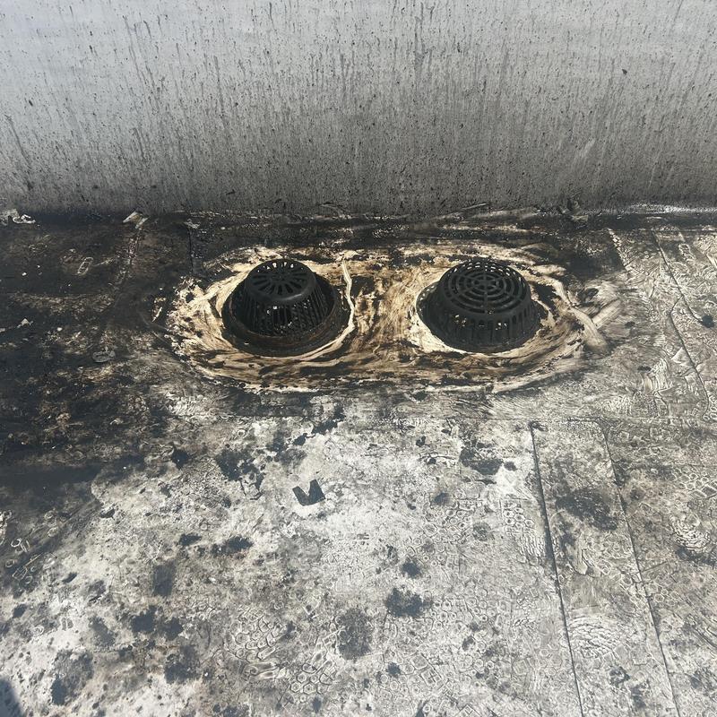 Roof drains with grease buildup and sealing residue