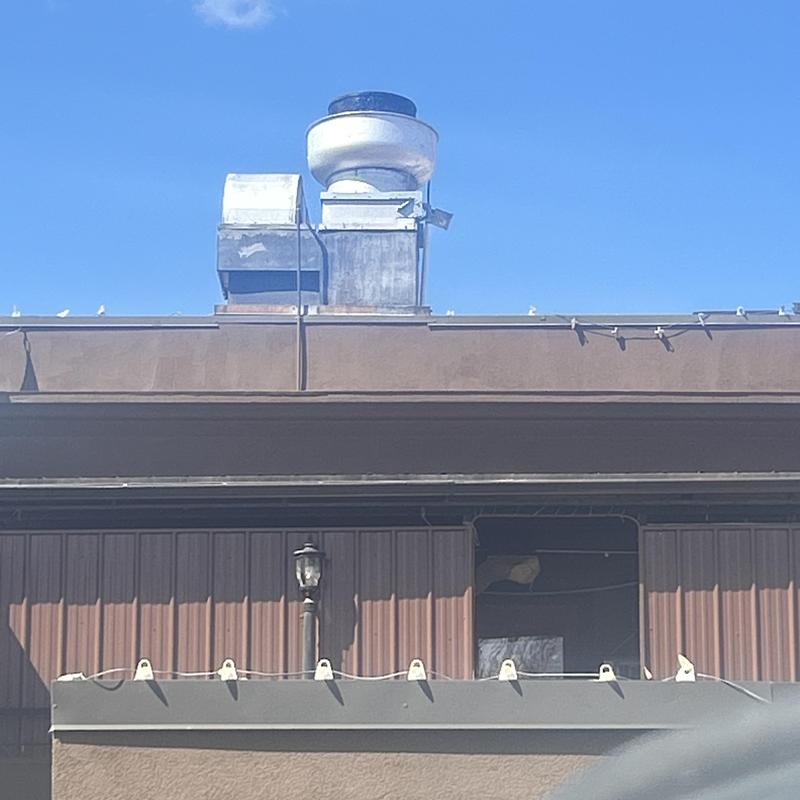 Roof drains with ventilation ducts on commercial building