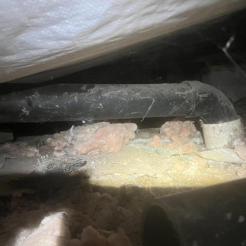 Kitchen sink drain pipe with elbow joint in crawl space