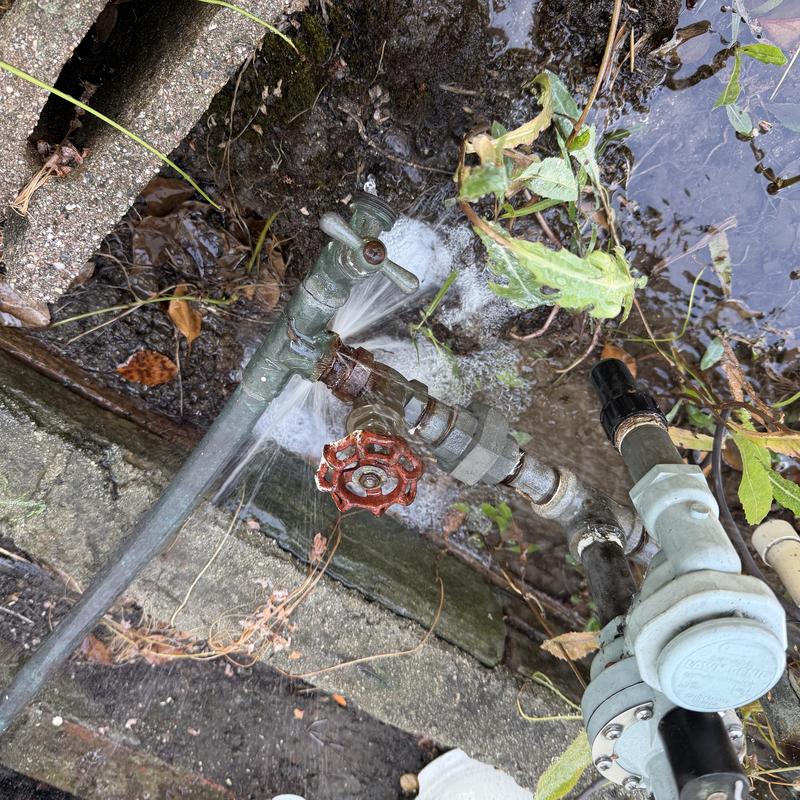 Copper irrigation piping with active water leak outdoors