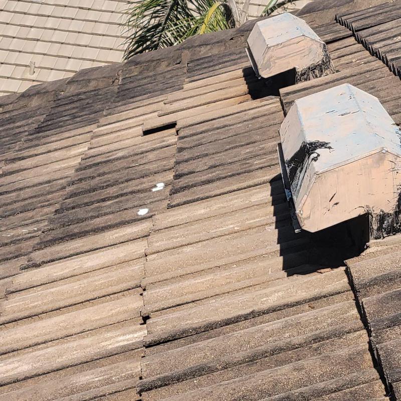 Concrete tile roof with broken and displaced tiles
