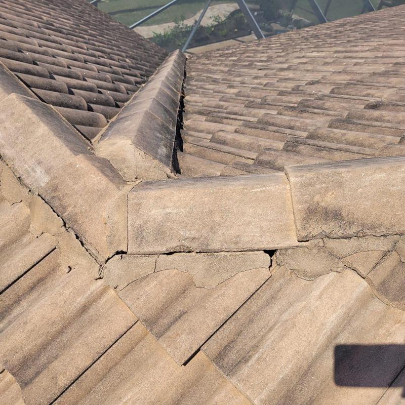 Concrete tile roof with cracked and displaced mortar