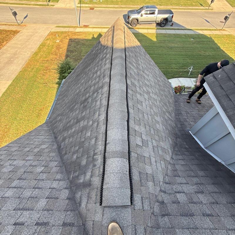 Asphalt shingle roof ridge with ridge vent installation