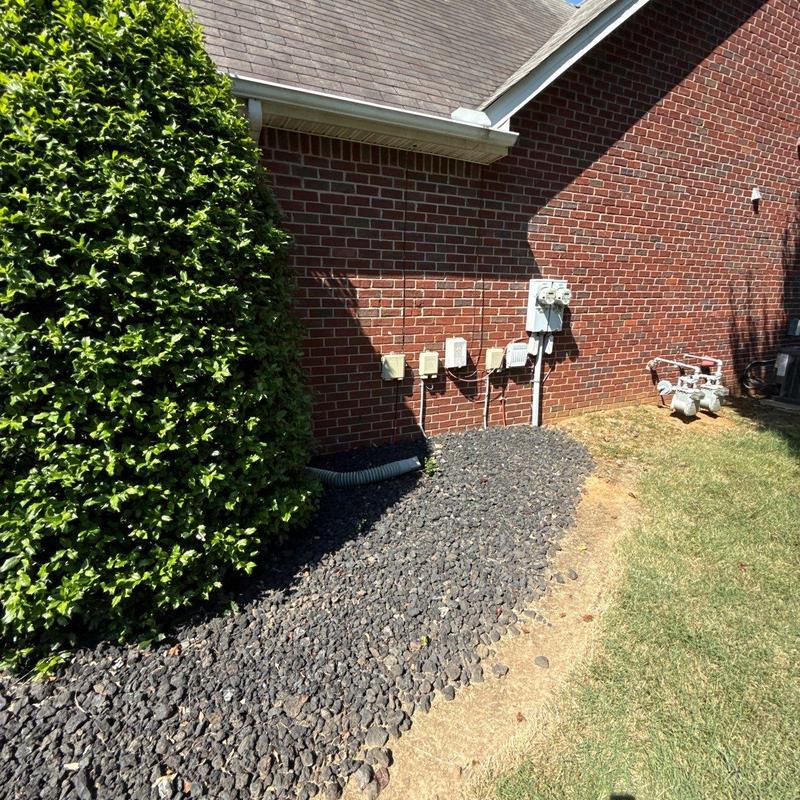 Gas meter and utility connections by brick wall