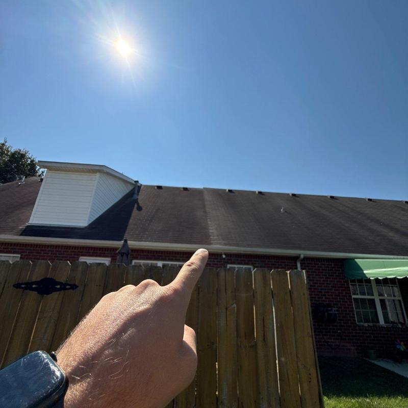 Roof shingles inspection with sun glare above