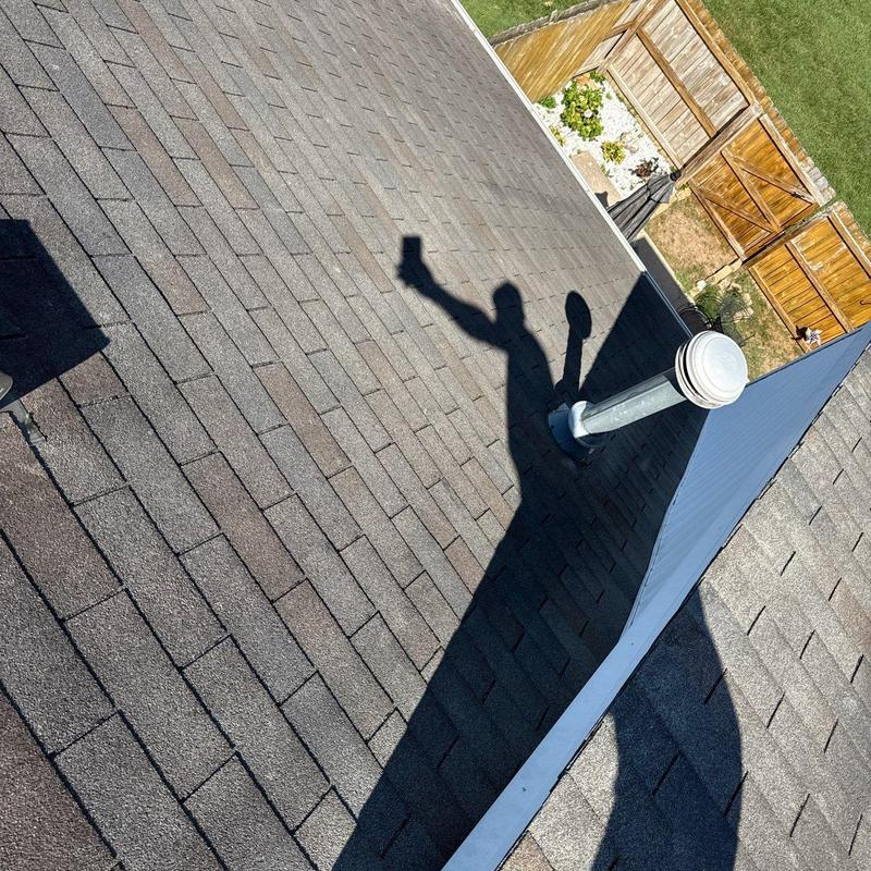 Asphalt shingle roof with vent pipe and fencing shadow