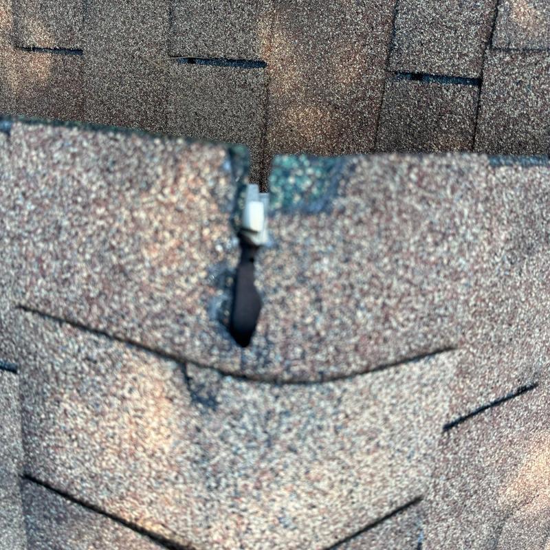 Roof shingles with hail damage close-up
